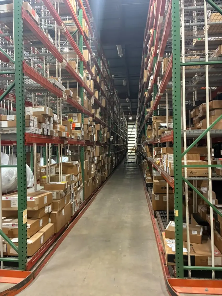 Stocked high-bay racking aisle at the Rush 24/7 warehouse